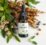 Bottle of Damiaplant Drops with natural ingredients in the background